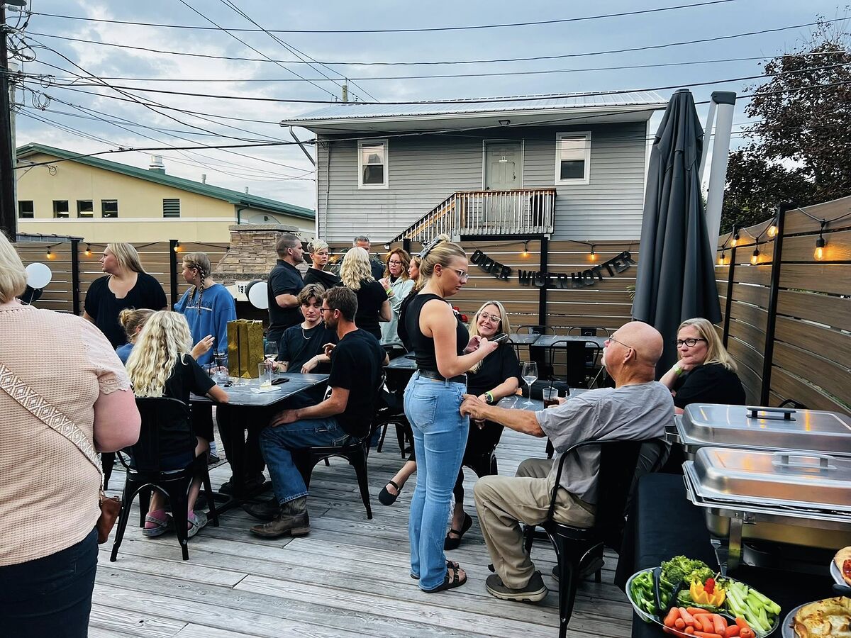Crowd enjoying live music on the patio at The Airport Inn Greene